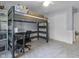 Bedroom with a lofted bed, built-in desk, and neutral tones, creating a versatile living space at 321 4Th E Ct, Carmel, IN 46033