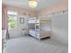 Bright bedroom featuring a bunk bed, and a large window, creating a comfortable and inviting space at 321 4Th E Ct, Carmel, IN 46033