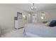 Light-filled bedroom features soft carpet, chandelier, and a dresser with modern decor and accents at 321 4Th E Ct, Carmel, IN 46033