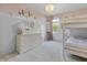 Charming bedroom with white wainscoting, a lovely chandelier, and a cozy bunk bed at 321 4Th E Ct, Carmel, IN 46033