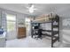 Bedroom featuring a lofted bed, built-in desk, and large windows, maximizing space and natural light at 321 4Th E Ct, Carmel, IN 46033