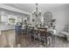 Inviting dining room featuring a wooden table, chairs, and an elegant chandelier, flowing into a modern kitchen area at 321 4Th E Ct, Carmel, IN 46033