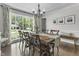 Elegant dining room with rustic table, chandelier, and large window at 321 4Th E Ct, Carmel, IN 46033