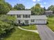 Traditional two-story home featuring a manicured front lawn and attached two car garage at 321 4Th E Ct, Carmel, IN 46033