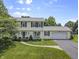 Charming two-story home with a manicured front lawn, curved walkway and attached two car garage at 321 4Th E Ct, Carmel, IN 46033