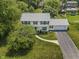 Aerial view of a two-story home featuring an attached garage, well-maintained lawn, and landscaped garden beds at 321 4Th E Ct, Carmel, IN 46033