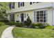 Up close view of home's entrance with curved sidewalk, landscaping, and many windows at 321 4Th E Ct, Carmel, IN 46033