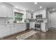 Bright kitchen with white cabinets, subway tile backsplash, stainless steel appliances, and a window view at 321 4Th E Ct, Carmel, IN 46033