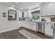 Well-lit kitchen showcasing white cabinets, stainless steel appliances, and hardwood floors for a sleek look at 321 4Th E Ct, Carmel, IN 46033