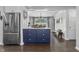 Charming eat-in kitchen with large refrigerator and a navy-colored island, perfect for entertaining at 321 4Th E Ct, Carmel, IN 46033
