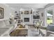 Cozy living room with a white brick fireplace, built-in bookshelves, and comfortable seating arrangement at 321 4Th E Ct, Carmel, IN 46033