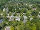 An aerial view showcases the neighborhood with mature trees, landscaped yards, and well-maintained homes at 321 4Th E Ct, Carmel, IN 46033
