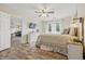 Relaxing bedroom featuring a large bed, wood floors, and bright natural light from multiple windows at 34 Westview Pl, Bargersville, IN 46106