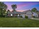 Charming single-story home with brick accents, well-manicured lawn, and cozy front porch at twilight at 34 Westview Pl, Bargersville, IN 46106
