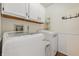 Functional laundry area with modern washer and dryer, overhead cabinets, and fresh, bright interior at 34 Westview Pl, Bargersville, IN 46106