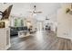Bright living room with wood floors, a ceiling fan, and large windows overlooking the greenery at 34 Westview Pl, Bargersville, IN 46106