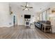 Open-concept living room featuring vaulted ceilings, wood floors, a fireplace, and a large dark couch at 34 Westview Pl, Bargersville, IN 46106