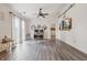 Cozy living room with light walls, wood floors, a ceiling fan, and bright natural light at 34 Westview Pl, Bargersville, IN 46106