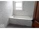 Bathroom featuring white subway tile and a built-in bathtub at 340 W 11Th St, Anderson, IN 46016