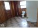 Bathroom with wood paneling, toilet, and storage shelves at 340 W 11Th St, Anderson, IN 46016