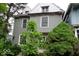Two-story home with gray siding, white trim, and mature trees at 340 W 11Th St, Anderson, IN 46016