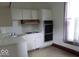 Efficient kitchen includes white cabinets and appliances, and a built-in double oven at 340 W 11Th St, Anderson, IN 46016