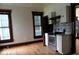 Bright kitchen features wood floor, stainless steel oven, grey backsplash and white cabinets at 340 W 11Th St, Anderson, IN 46016