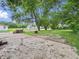 Spacious backyard with mature trees and a concrete slab at 3526 E Vermont St, Indianapolis, IN 46201