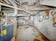 Unfinished basement with exposed brick foundation, visible pipes, and electrical panel at 3526 E Vermont St, Indianapolis, IN 46201