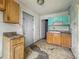 Dated kitchen with base and upper cabinets, sink, and a back door at 3526 E Vermont St, Indianapolis, IN 46201