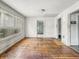 Living room featuring hardwood floors, multiple windows and doorways at 3526 E Vermont St, Indianapolis, IN 46201