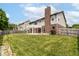 Expansive backyard with lush lawn, pergola-covered patio, and brick chimney for outdoor enjoyment at 4650 Blue Marlin Way, Indianapolis, IN 46239