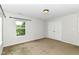 Spacious bedroom with neutral carpet, a large window, and a double-door closet at 4650 Blue Marlin Way, Indianapolis, IN 46239