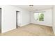 Cozy bedroom with neutral carpet, a large window, and a closet at 4650 Blue Marlin Way, Indianapolis, IN 46239