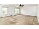 This spacious bedroom has carpet floors, a ceiling fan, and two windows bringing in natural light at 4650 Blue Marlin Way, Indianapolis, IN 46239
