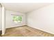 Bright carpeted bedroom features a window with natural light and neutral decor at 4650 Blue Marlin Way, Indianapolis, IN 46239