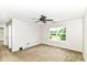 This bedroom has carpet floors, a ceiling fan, and a window bringing in natural light at 4650 Blue Marlin Way, Indianapolis, IN 46239