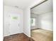 Entryway with a front door and a view into a carpeted living space at 4650 Blue Marlin Way, Indianapolis, IN 46239