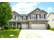 Charming two-story home featuring a well-manicured lawn and a two-car garage with an appealing stone and brick facade at 4650 Blue Marlin Way, Indianapolis, IN 46239