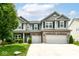 Charming two-story home with a well-manicured lawn, two-car garage, and beautiful stone and siding exterior at 4650 Blue Marlin Way, Indianapolis, IN 46239