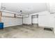 Spacious garage with white walls, concrete floor, and automatic door; ample storage at 4650 Blue Marlin Way, Indianapolis, IN 46239
