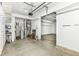 A large and empty garage, white walls, a concrete floor, and room for storage at 4650 Blue Marlin Way, Indianapolis, IN 46239