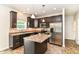 Well-equipped kitchen with dark cabinets, stainless steel appliances, and an island, blending style and functionality seamlessly at 4650 Blue Marlin Way, Indianapolis, IN 46239