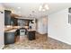 Well-equipped kitchen features stainless steel appliances, an island, and warm-toned tile floors at 4650 Blue Marlin Way, Indianapolis, IN 46239