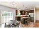 Inviting kitchen with dark cabinetry, stainless steel appliances, and an island, offering style and functionality at 4650 Blue Marlin Way, Indianapolis, IN 46239