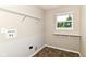 Laundry room with shelving, utility sink hookups, and a bright window view at 4650 Blue Marlin Way, Indianapolis, IN 46239