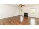 Bright living room offers hardwood floors, a ceiling fan, and a cozy fireplace at 4650 Blue Marlin Way, Indianapolis, IN 46239