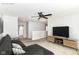Cozy upstairs living room with comfortable seating, a ceiling fan, and a large television, perfect for relaxation at 4650 Blue Marlin Way, Indianapolis, IN 46239