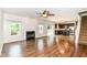 Open-concept living area with hardwood floors, a fireplace, and a view of the kitchen at 4650 Blue Marlin Way, Indianapolis, IN 46239