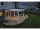 Cozy backyard patio featuring a pergola, outdoor lighting, fire pit, and a well-maintained lawn at 4650 Blue Marlin Way, Indianapolis, IN 46239